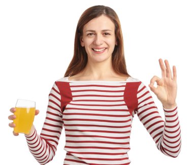 Bir bardak meyve suyu içen mutlu bir kadın beyaz arka planda iyi bir jest yapıyor.