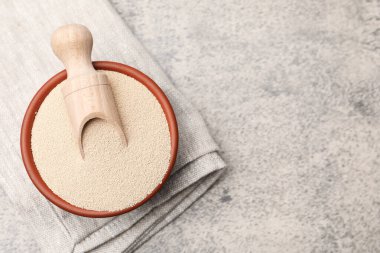 Kuru maya ve kepçeyle gri masada, üst manzara. Metin için boşluk