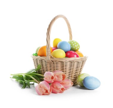 Paskalya sepeti boyalı yumurtalar ve beyaz üzerinde izole edilmiş güzel laleler.