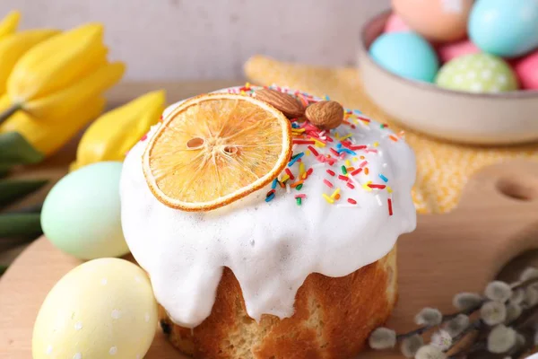 Lezzetli Paskalya pastası, boyanmış yumurtalar, söğüt dalları ve masada laleler, yakın plan.