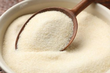 Kavanozda kuru jelatin tozu, masada kaşık, yakın plan.