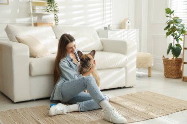 Evdeki kanepenin yanında tatlı köpeği olan bir kadın, mesaj atmak için yer var.