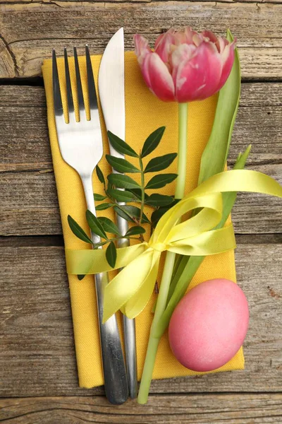 Paskalya sofrası. Lale ve ahşap arka planda boyalı yumurta ile güzel gümüş takımlar, üst manzara.