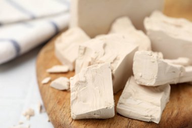 Beyaz döşeme üzerinde taze maya parçaları, yakın plan.