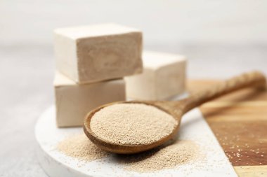 Gri desenli masada taze, kurutulmuş maya ve kaşık parçaları, yakın plan.