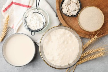 Çiğ hamur, malzemeler ve çiviler gri masada, düz yerde