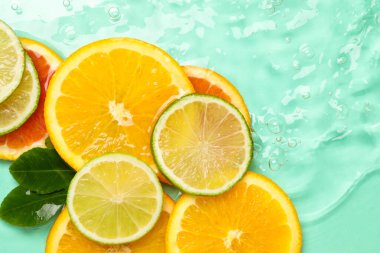 Turkuaz arka planda turkuaz meyveler ve yeşil yapraklar. Metin için boşluk