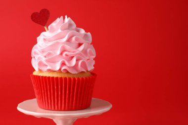 Sevgililer Günün kutlu olsun. Kırmızı arka planda kalp kaplaması olan leziz bir kek, yakın plan. Metin için boşluk