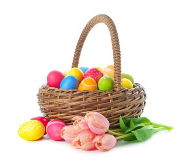 Paskalya sepeti boyalı yumurtalar ve beyaz üzerinde izole edilmiş güzel laleler.
