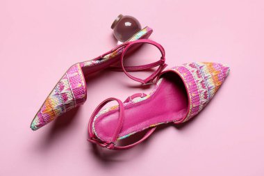 Pembe arka planda bir çift güzel ayakkabı.