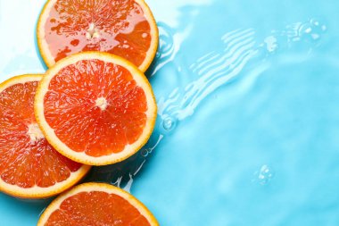 Açık mavi zemin üzerinde su içinde narenciye dilimleri, düz yatıyordu. Metin için boşluk