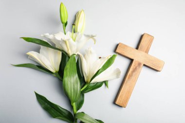 Paskalya. Ahşap haç ve gri arka planda güzel zambak çiçeği.