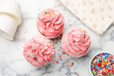 Beyaz mermer masaya serpiştirilmiş lezzetli kekler.