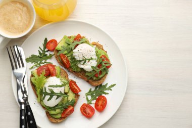 Avokado tostları ve hafif ahşap masada servis edilen haşlanmış yumurtalarla nefis bir kahvaltı. Metin için boşluk