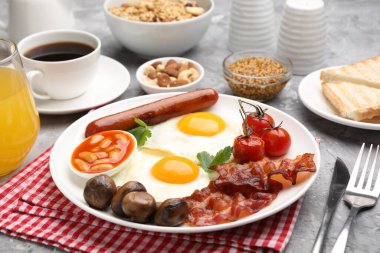 Geleneksel İngiliz kahvaltısı desenli gri masada servis edilir, yakın plan.