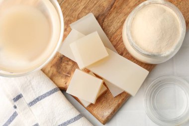 Kasede jelatin, toz, jöle parçaları ve masada bir bardak su, düz uzanmış.