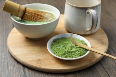 Seramik kasede taze yeşil kibrit, bambu çırpı, toz, bardak ve ahşap masada kepçe, yakın çekim