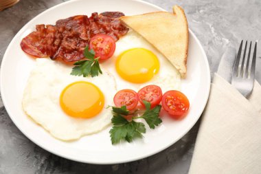 Yağda yumurta ve pastırma ile nefis bir kahvaltı. Dokuma masasında servis ediliyor. Yakın plan.