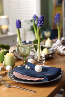 Paskalya kutlaması. Çiçekli şenlik masası ve kapalı mekanda yumurtalar, yakın plan.