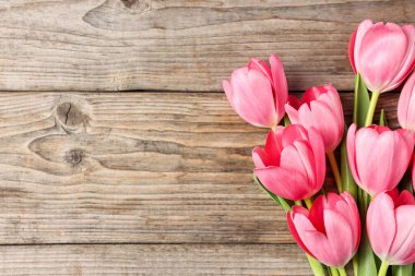 Ahşap masanın üstünde güzel pembe laleler, üst manzara. Metin için boşluk