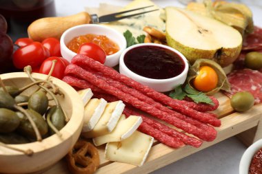 Işık masasında bir sürü aperatif bulunan şarküteri tahtası, yakın plan.