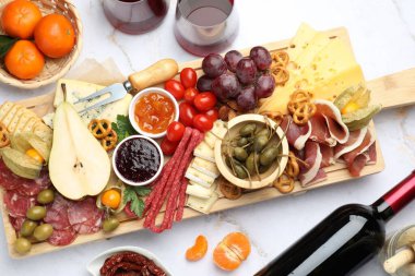 Bir sürü aperatif ve şaraplı şarküteri tahtası açık mermer masada, düz yatıyordu.