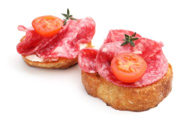 Salamlı, domatesli, krem peynirli ve kekikli nefis bruschettalar beyaz üzerine izole edilmiş.