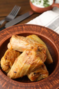 Tahta masada servis edilen lezzetli lahana dürümleri, yakın plan.