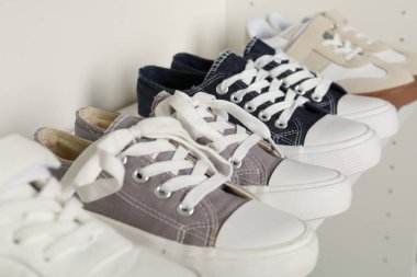 İçerideki raflarda farklı tarz çocuk ayakkabıları, yakın plan.