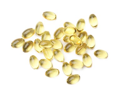 Altın jelatin kapsül yığını beyaz, üst görünümde izole