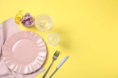 Sarı arka planda çiçek dekoru olan güzel bir masa. Metin için boşluk