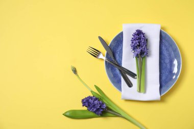 Sarı arka planda çiçek dekoru olan güzel bir masa.