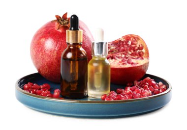 Beyaz üzerine izole edilmiş gerekli yağ ve taze nar şişeleri.