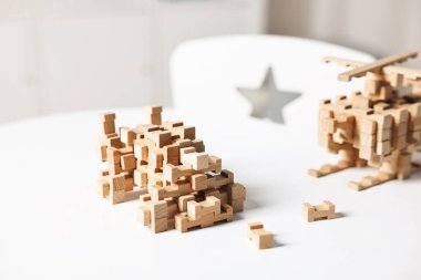 Beyaz masadaki tahta bloklardan yapılmış araba figürü, yakın plan.