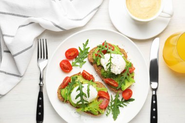 Avokado tostları ve hafif ahşap masada servis edilen haşlanmış yumurtalarla nefis bir kahvaltı.