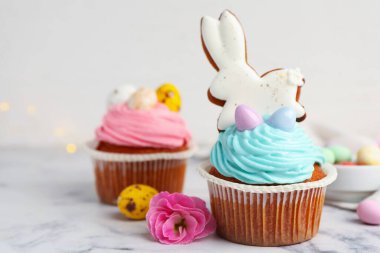 Beyaz mermer masada Paskalya dekoru olan lezzetli kekler, yakın plan.