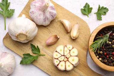 Taze sarımsak, biber, biberiye ve maydanoz açık gri masada, düz yatıyordu.