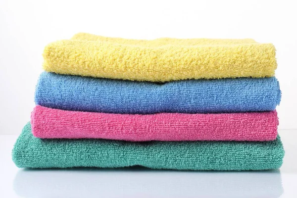 Beyaz üzerine izole edilmiş renkli havlu yığını