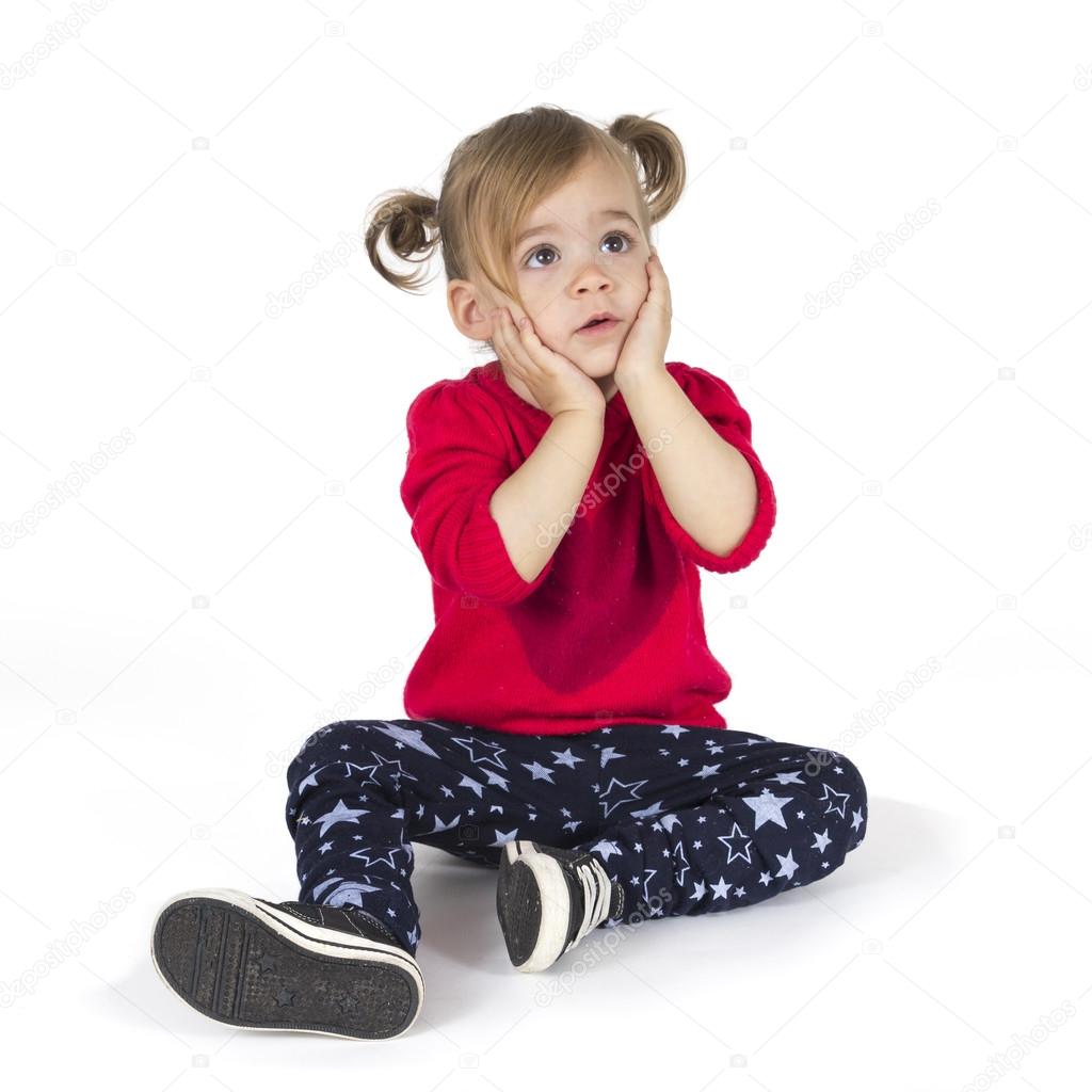 Baby girl sitting and make a gesture with hands