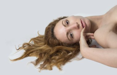 Kadın uzandı ve kırmızı saçları yaymak