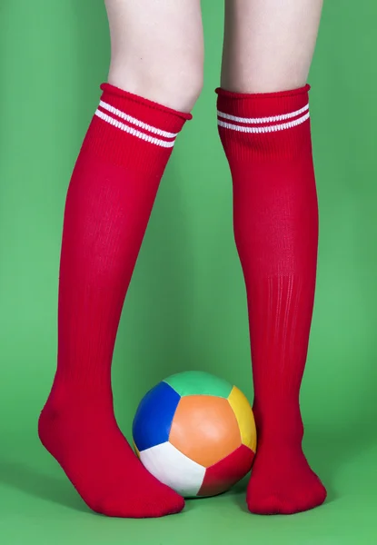 Red socks long legs and football — Stock Photo, Image