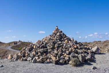 Yunanistan 'ın Santorini kentindeki Nea Kameni Adası' ndaki Büyük Volkanik Kaya Cairn Yığını Mavi Gök Altında