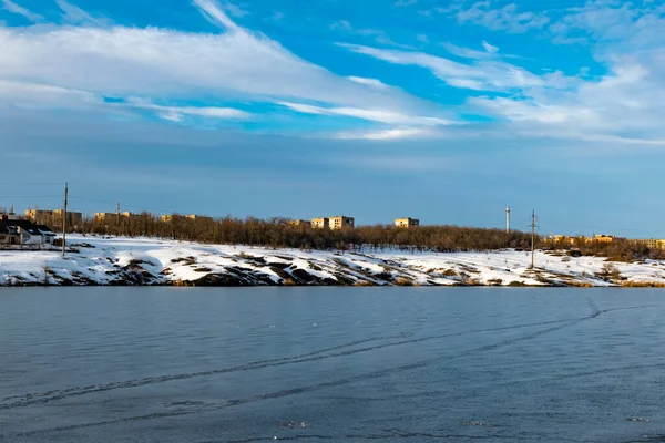 Spacious snow landscape. River and hills in Russia, white winter on the terrain, a lot of fluffy snow and ice under a beautiful blue sky. Rostov region, town of Shakhty, the river Grushevka