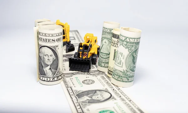 Žlutá Hračka Buldozer Staví Cestu Dolarových Bankovek — Stock fotografie