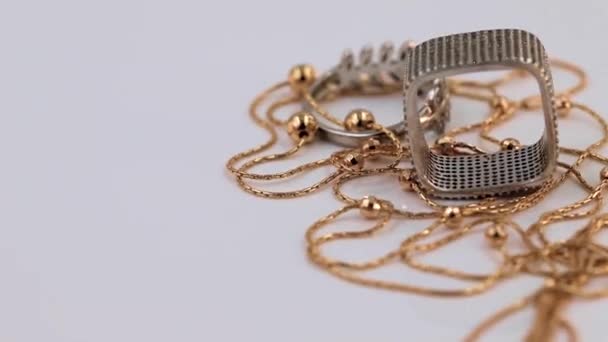 不同形状的银环和金链绕着它的轴旋转 — 图库视频影像