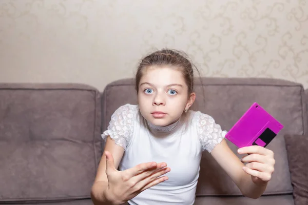 A girl from high school is very surprised to see a floppy disk for the first time