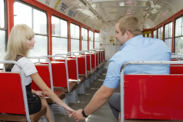 Young guy to get acquainted with a cute girl in the tram — Stock Photo, Image