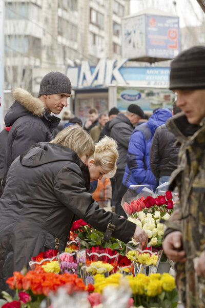 Selling flowers at a makeshift flower markets on the eve of international women's day