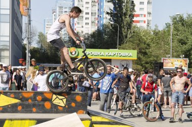 BMX cyclist performs a stunt on the ramp clipart