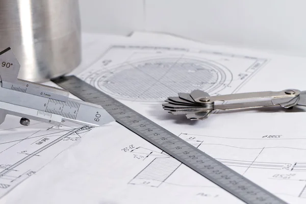 Templates for visual measurement control are on the drawing pipe — Stock Photo, Image